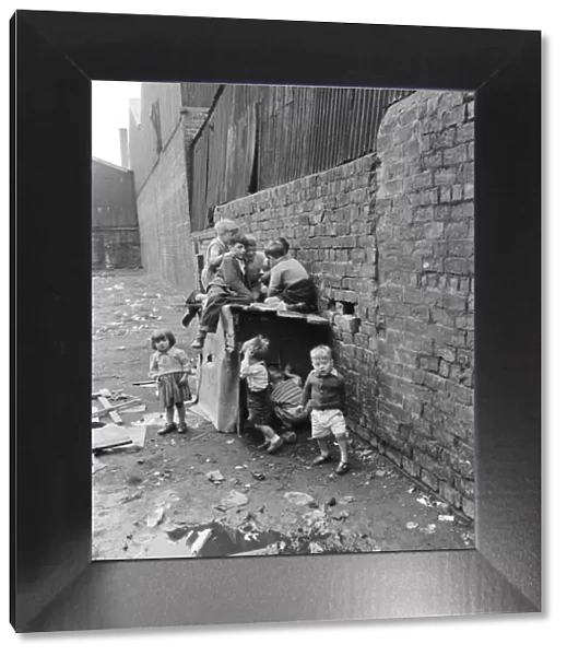 Children playing in the back alleys of a Goven tenement block. September 1956