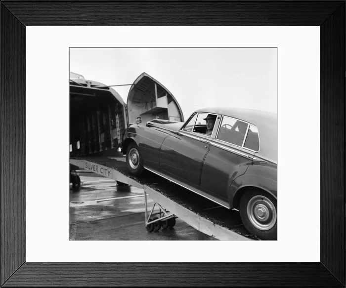 Framed Print : Actor Alec Guinness loading his Bently onto an aircraft bound for France where he will