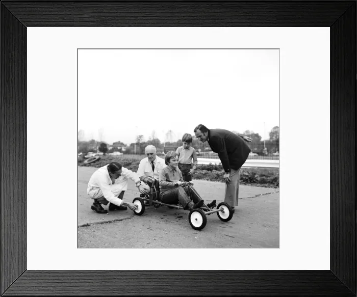 Framed Print : Rober Spicer on the Skid Pan. Skid Pan officials, adjust the Go Kart prior to Robert