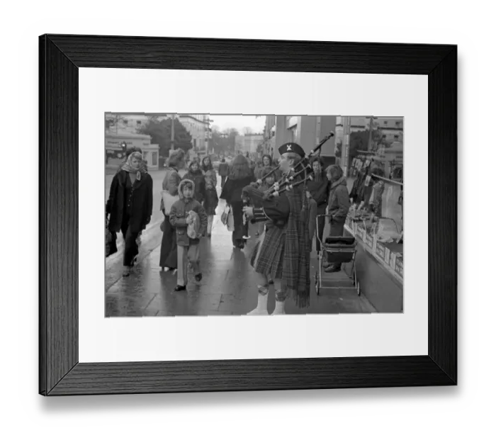 Framed Print : A piper plays the bagpipes dressed in full Scottish national costume including a kilt in