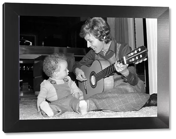 International singer star: Caterina Valente serenades her son. February 1975 75-00827-007