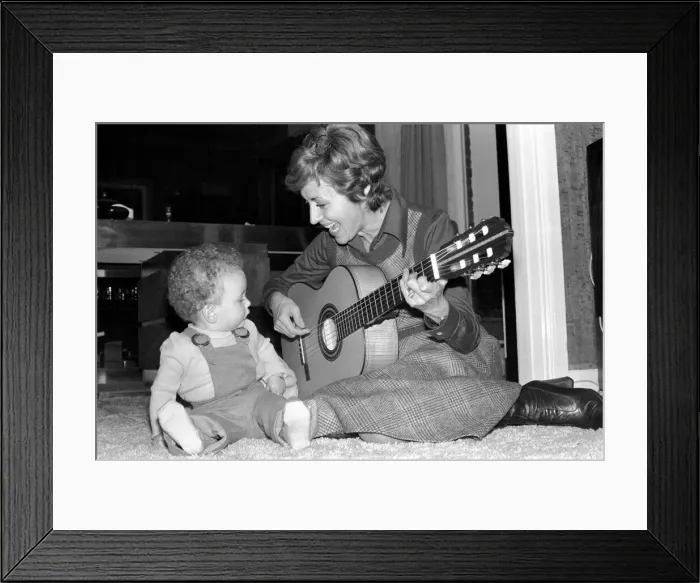 Framed Print : International singer star: Caterina Valente serenades her son. February 1975 75-00827-007 Framed Print : International singer star: Caterina Valente serenades her son. February 1975 75-00827-007