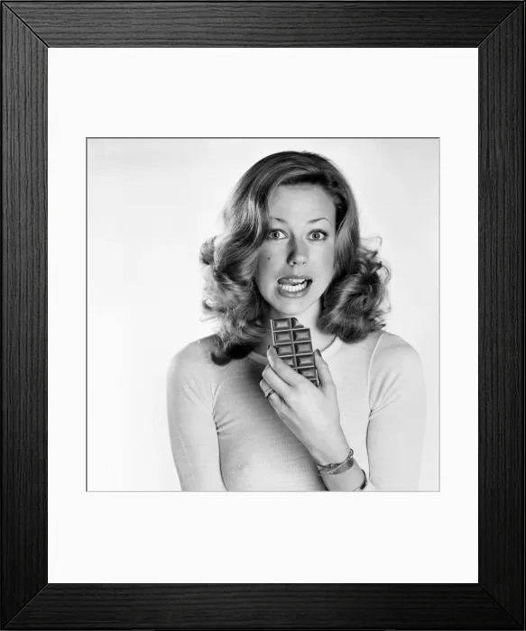 Framed Print : Woman eating chocolate. February 1975 75-00891-001 Framed Print : Woman eating chocolate. February 1975 75-00891-001