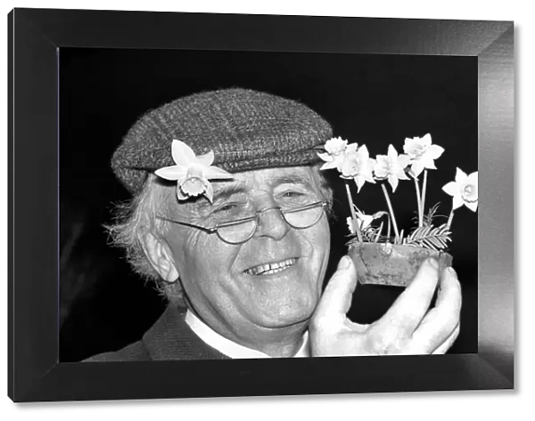Mr. Allan Warner. Man with flowers. January 1975 75-00531-001