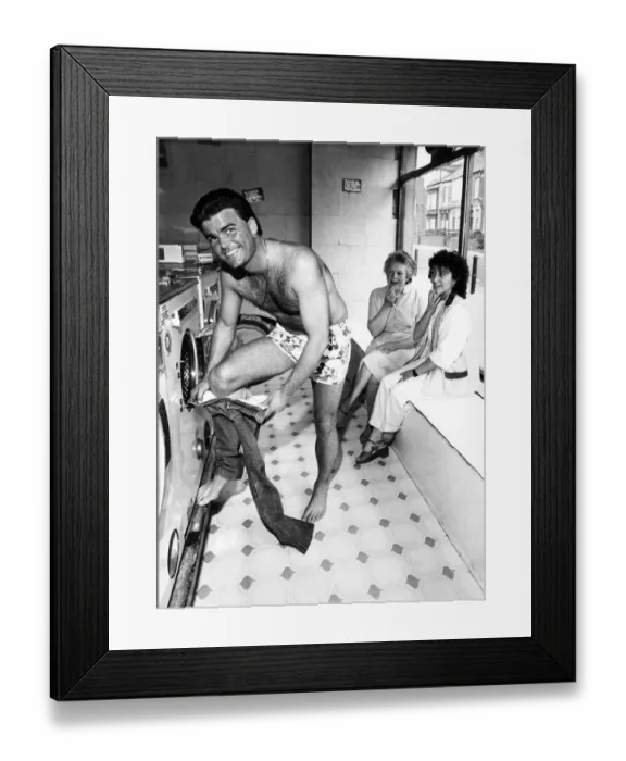 Framed Print : Women shoppers stop and stare as Tony Carlisle takes off a well known T