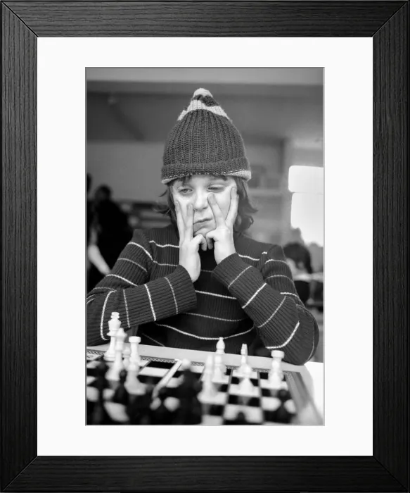 Framed Print : East End Kids Chess Congress: A West Ham supporter, complete with his West Ham hat makes