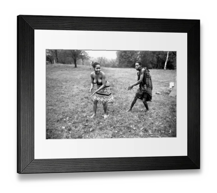 Framed Print : African Dancing: Ghanan Dancers. A bare-topped dancer gets chased by one of the boy Framed Print : African Dancing: Ghanan Dancers. A bare-topped dancer gets chased by one of the boy