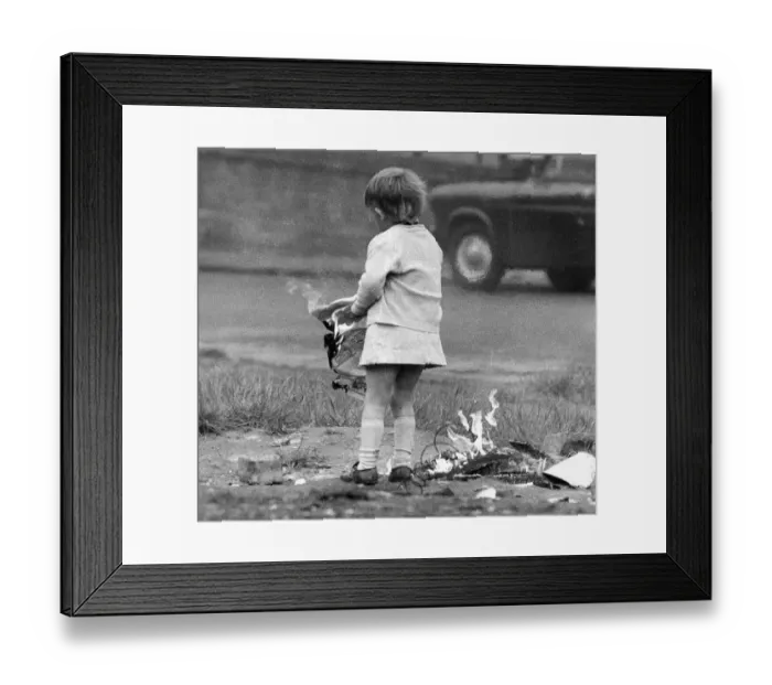 Framed Print : A young girl risks injury playing with fire on wasteland November 1972 Framed Print : A young girl risks injury playing with fire on wasteland November 1972