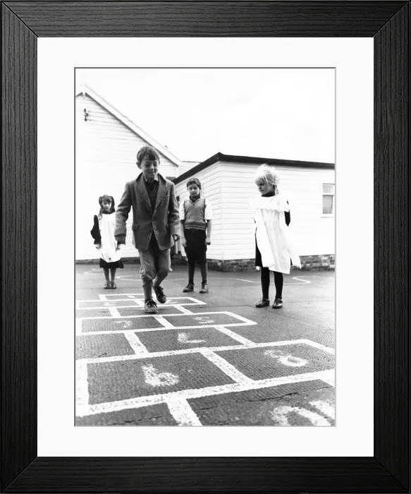Framed Print : Whittonstall Fist School pupils play hopscotch as part of their 75th anniversary