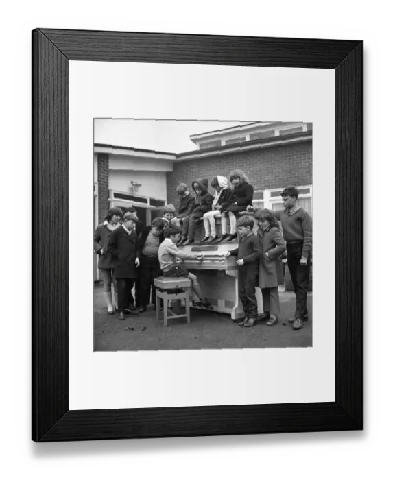 Framed Print : Eleven year old Martin Hawes entertains his school friends to a tune on the John Lennon