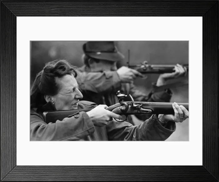 Framed Print : Mrs. Bell is seen firing a British Army piece called Brown Bess Framed Print : Mrs. Bell is seen firing a British Army piece called Brown Bess