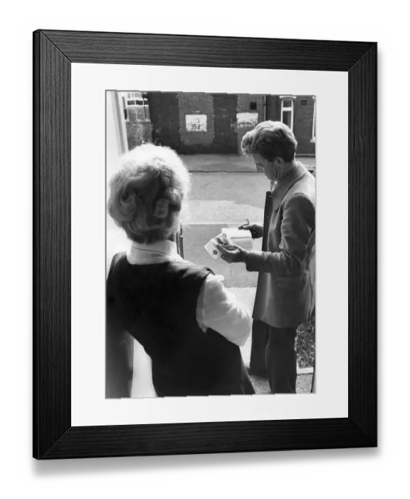 Framed Print : Rent collector collecting weekly rent from a tenant. September 1975 P005425
