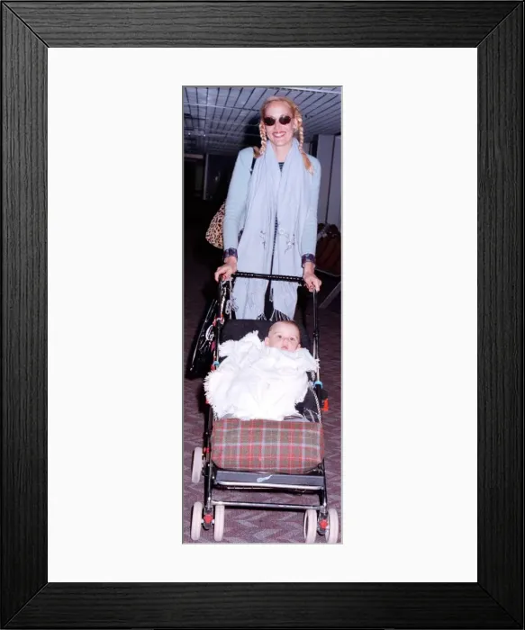 Framed Print : Jerry Hall and baby arrive at London Airport from New York and their Christmas holiday