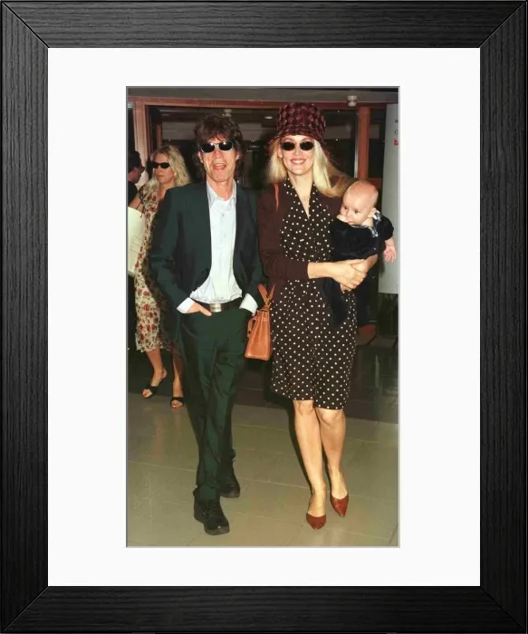 Framed Print : Mick Jagger pop singer and wife Jerry with their new baby leave Heathrow for Nice