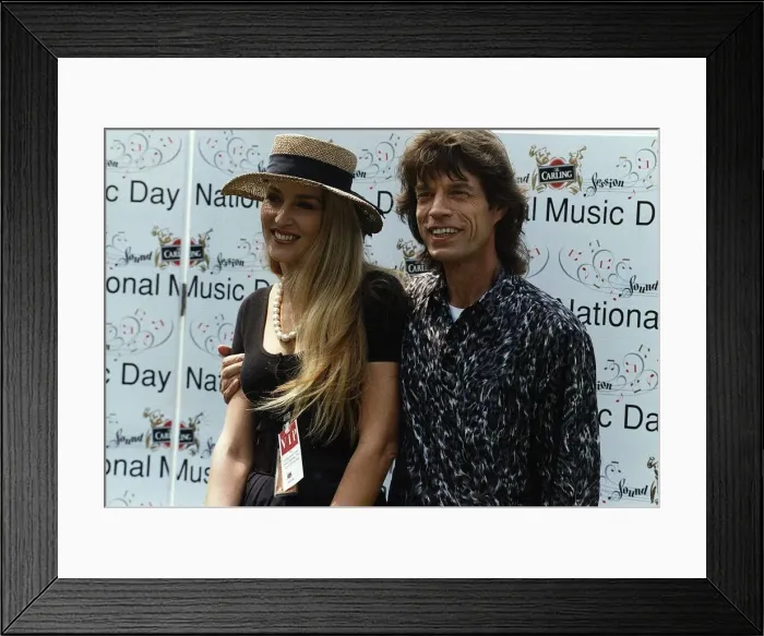 Framed Print : Mick Jagger poses with his wife Jerry Hall at a national music day celebration in London