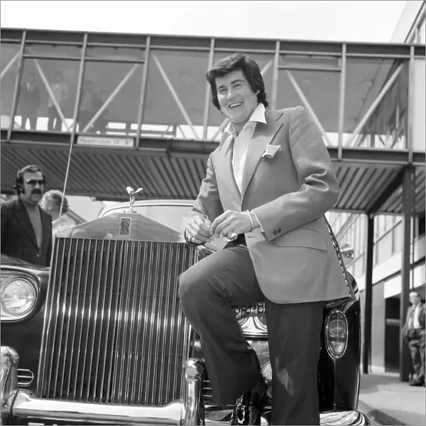 Wayne Newton looking very happy as he leans against a gleaming Rolls-Royce on his arrival
