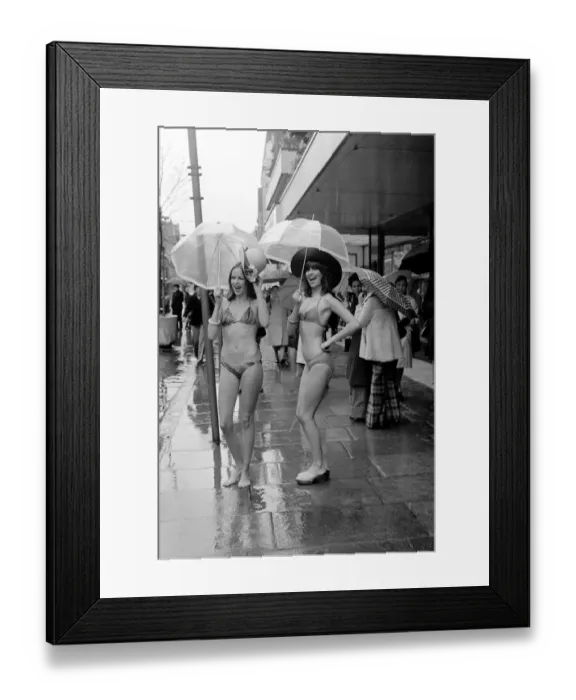 Framed Print : Models Wendy and Jackie seen here modeling the latest in swimwear on a wet Oxford Street Framed Print : Models Wendy and Jackie seen here modeling the latest in swimwear on a wet Oxford Street