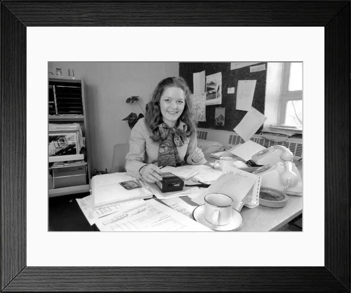 Framed Print : A desk covered with paper, empty coffee mugs and a calculator symbols of the busy