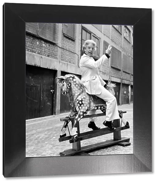 Wrestler Jackie Pallo poses with a rocking horse. February 1975 75-01087