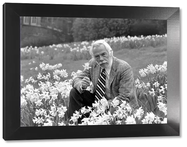 American actor Lee Marvin smelling the spring flowers during a visit to England
