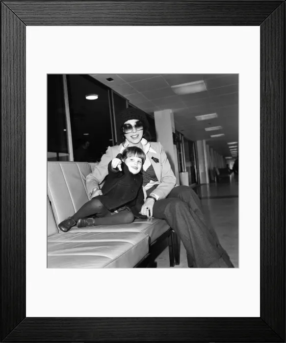 Framed Print : Actress Joan Collins and her 2 year old daughter Katyania leaving Heathrow airport for Framed Print : Actress Joan Collins and her 2 year old daughter Katyania leaving Heathrow airport for