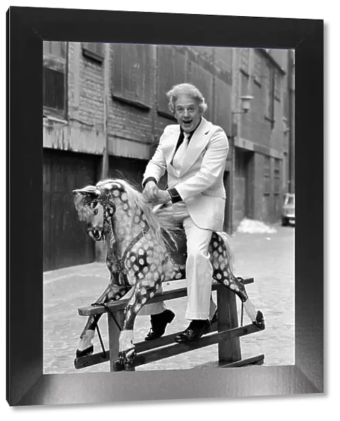 Wrestler Jackie Pallo poses with a rocking horse. February 1975