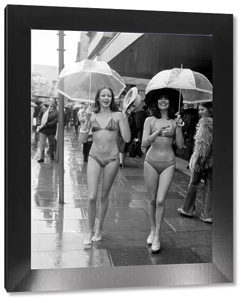 Models Wendy and Jackie seen here modeling the latest in swimwear on a wet Oxford Street