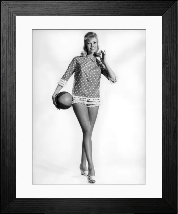 Framed Print : Model Jo Waring wearing a polka dot patterned top and holding a beach ball