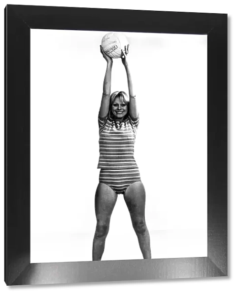 Woman doing her slimming exercises using a beach ball. Circa 1966