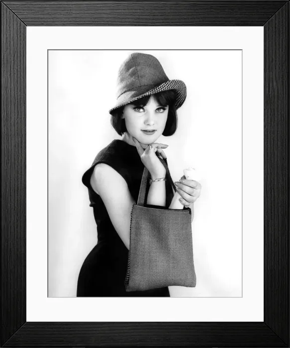 Framed Print : Model wearing a sleveless black dress and hat whilst holding a shopping handbag