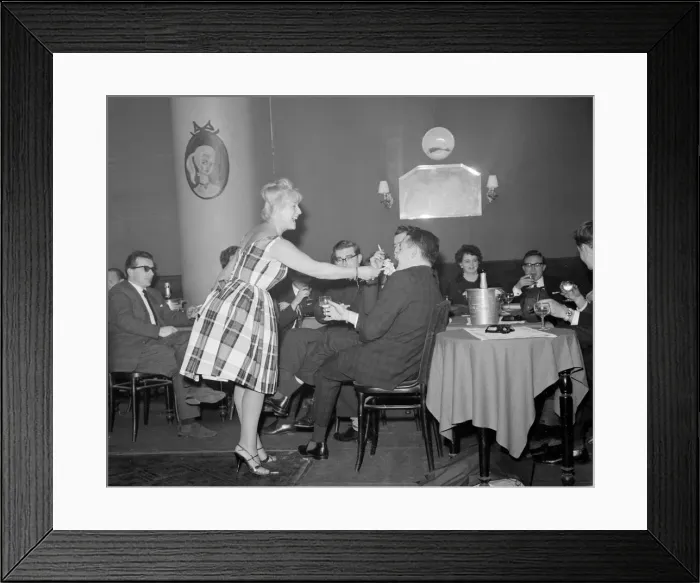 Framed Print : Monte Carlo Rally winner Paddy Hopkirk enjoys the attention of a hostess in a Monte Carlo