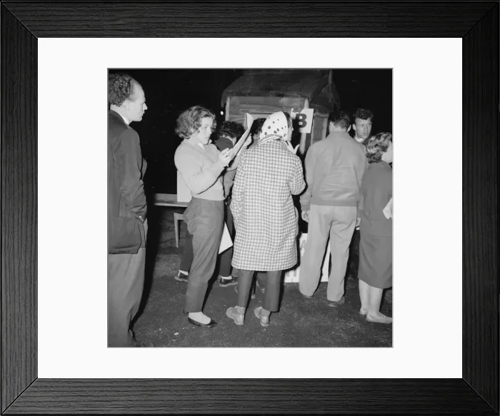 Framed Print : British racing drivers Pat Moss and Ann Wisdom check in looking tired after finishing