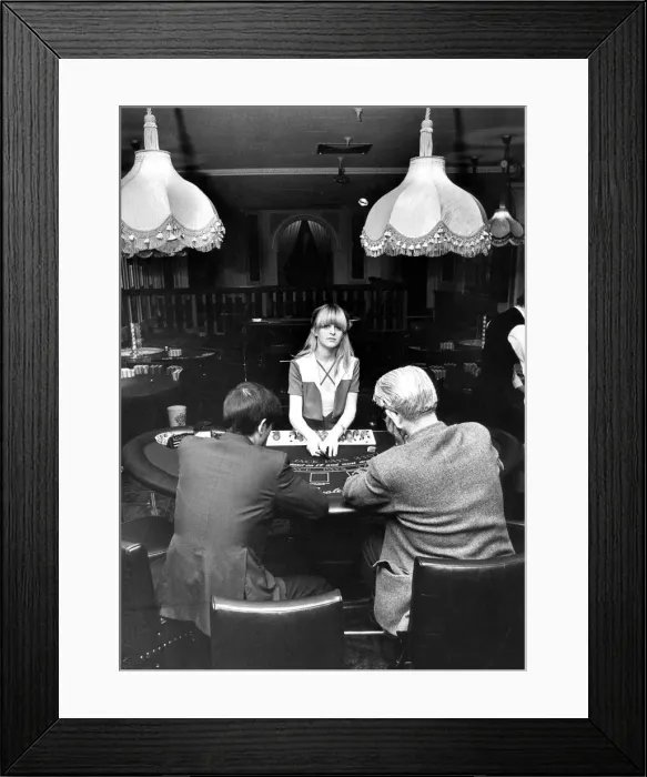Framed Print : Sherrill Crabtree deals the cards at the Black jack tables in the newly opened Casino