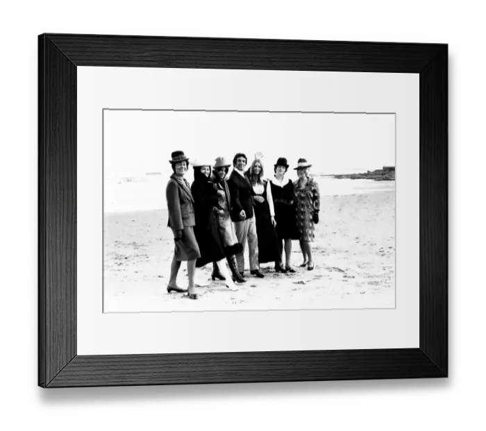 Framed Print : Singer Frankie Vaughan strolling along the beach with some of the models from a fashion