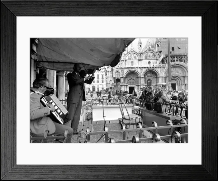 Framed Print : General scenes in Venice. Fiddling while Venice sinks. Signor Ninor Brunello leads a Framed Print : General scenes in Venice. Fiddling while Venice sinks. Signor Ninor Brunello leads a