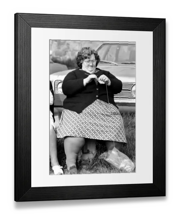 Framed Print : A women with larger figure seen here knitting whilst their children play in a poorer Framed Print : A women with larger figure seen here knitting whilst their children play in a poorer