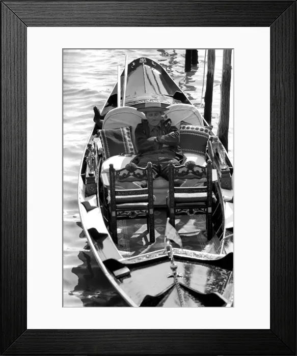 Framed Print : General scenes in Venice. A gondolier catches a quick forty winks between fares