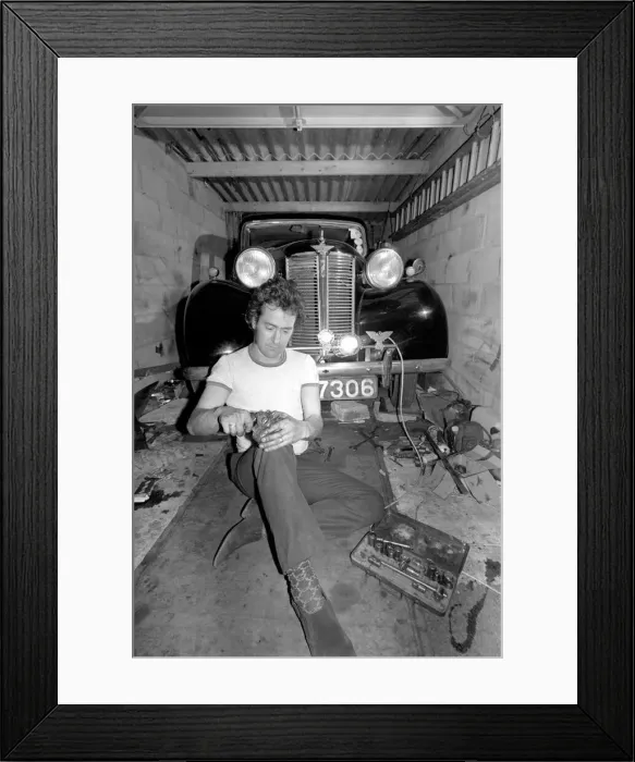 Framed Print : Mechanic underneath a car, making repairs April 1975 75-02158-013 Framed Print : Mechanic underneath a car, making repairs April 1975 75-02158-013
