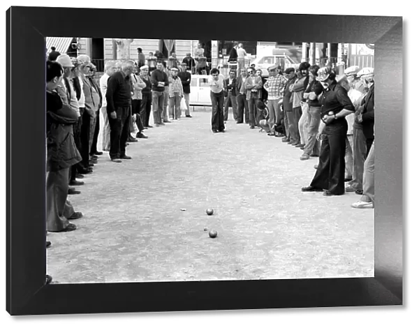 Frenchmen play Boules in the streets of Poussan, France. April 1975 75-2097-003