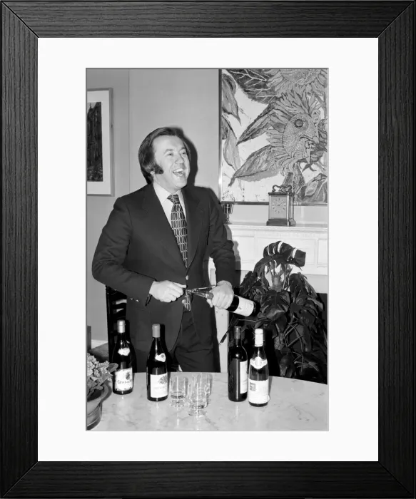 Framed Print : Wine: Mr. David Frost trying to open a bottle of wine at his home Framed Print : Wine: Mr. David Frost trying to open a bottle of wine at his home