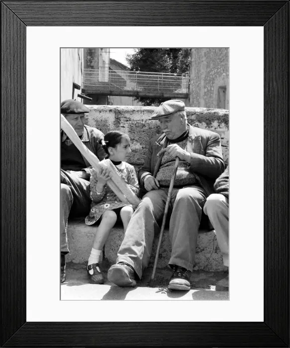 Framed Print : 6 year old Nathalie Rustan with her French loaves of bread talks to pensioner Michel