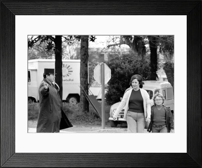 Framed Print : A French Gendarme holds up the traffic as Mrs. Maria Quaranta aged 36