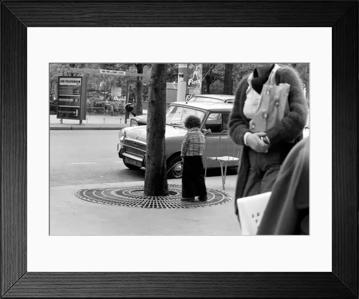 Framed Print : Young boy urinates outside a cafe on the Champs Elysees in Paris, France Framed Print : Young boy urinates outside a cafe on the Champs Elysees in Paris, France