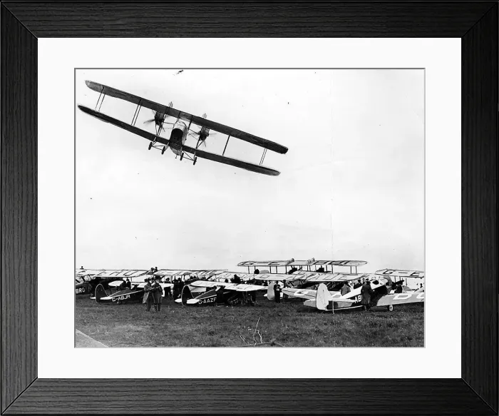 Framed Print : A Handley Page W-8 banks over the parked aircraft at Cramlington airfield