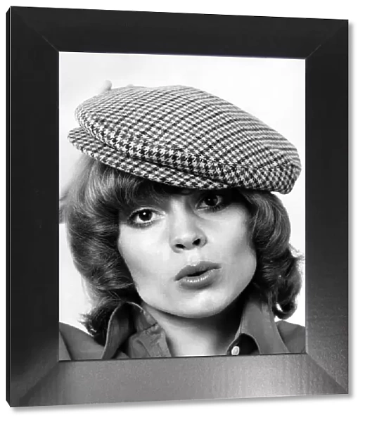 Model Amanda tries a cloth cap. May 1973 P007870