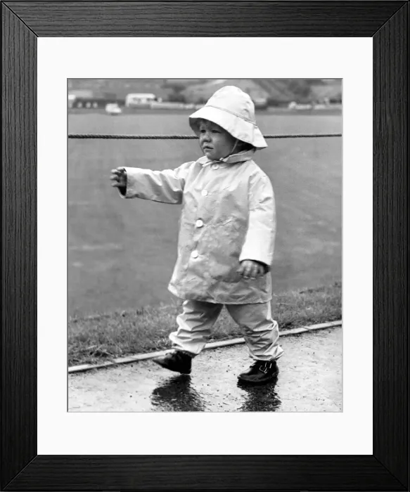 Framed Print : Durham Miners Gala - Young Andrew Mangan is prepared for the wet weather in his Framed Print : Durham Miners Gala - Young Andrew Mangan is prepared for the wet weather in his