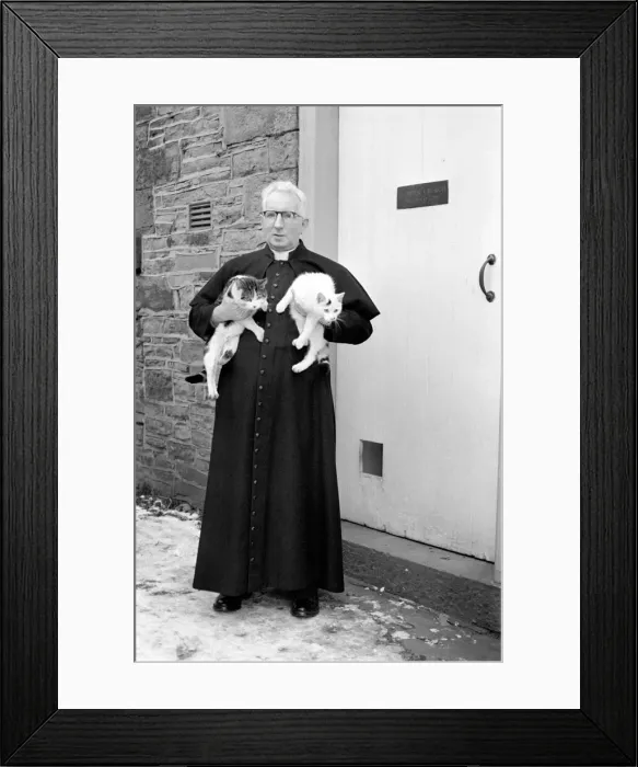 Framed Print : The parish priest seen here gathering up his pet cats February 1970 70-1627-005