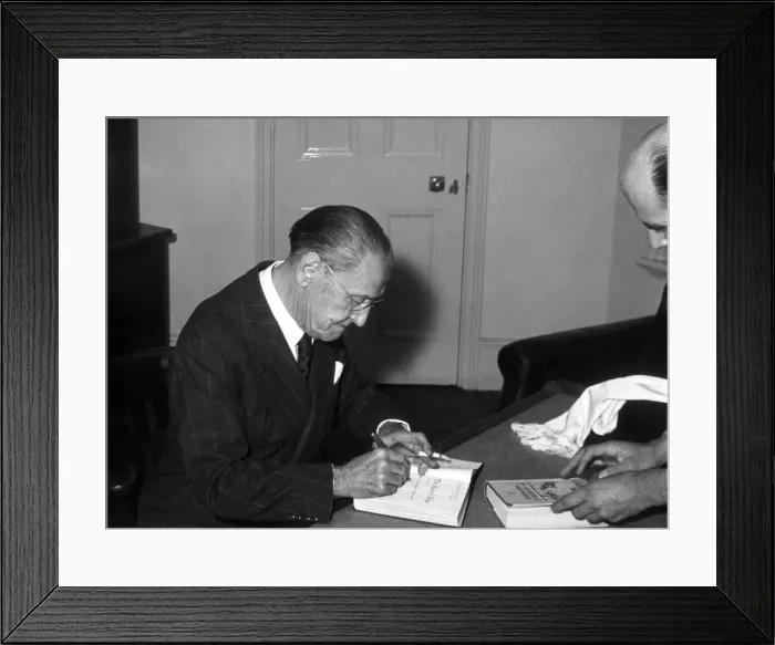 Framed Print : Somerset Maugham signs a copy of his book after his lecture on The writer Framed Print : Somerset Maugham signs a copy of his book after his lecture on The writer