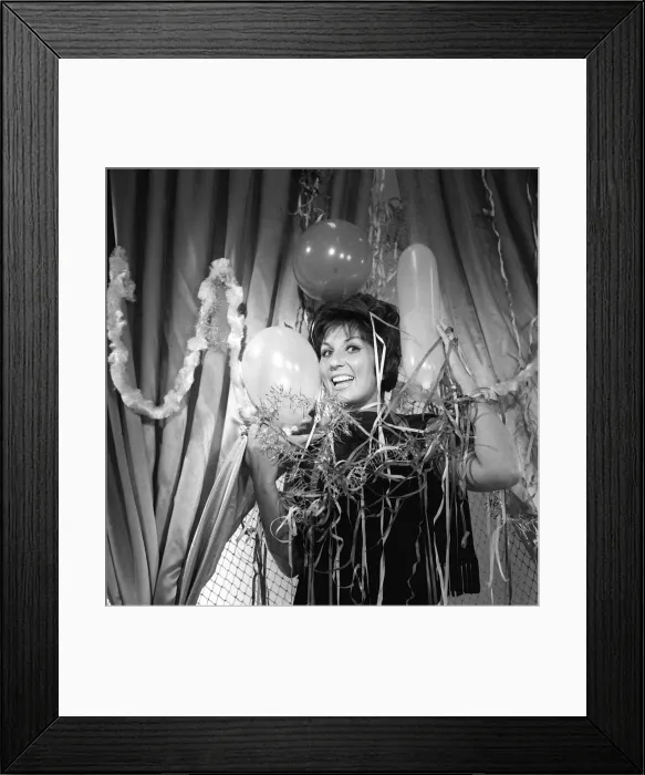 Framed Print : British singer Alma Cogan wraps herself in Christmas decorations at ATV House in Marble