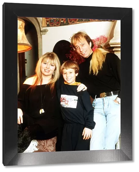 Robin Gibb of the Bee Gees pop group at home with his wife and son